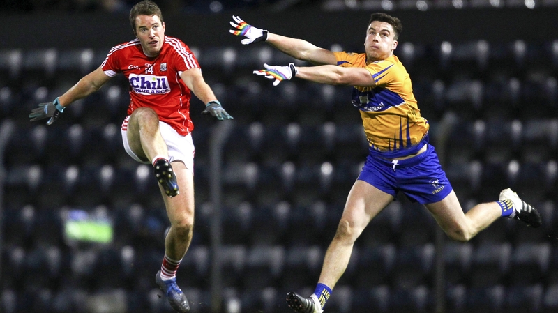 Cork's Colm O'Neill shoots under pressure from Jamie Malone of Clare