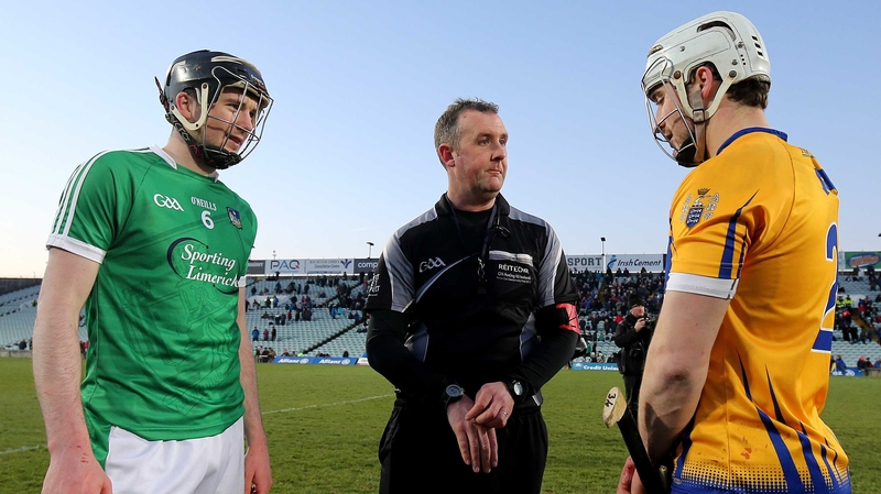 Limerick's Declan Hannon and Clare's Paul O'Connor with referee Alan Kelly at the coin toss for the free decider