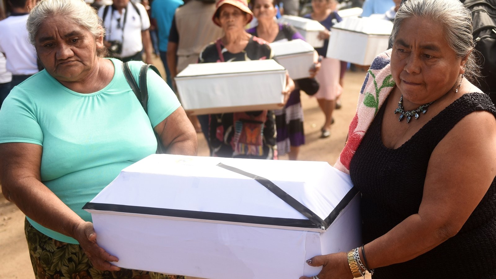 Relatives bury the exhumed remains of 21 children killed during the El Mozote massacre in 1981.