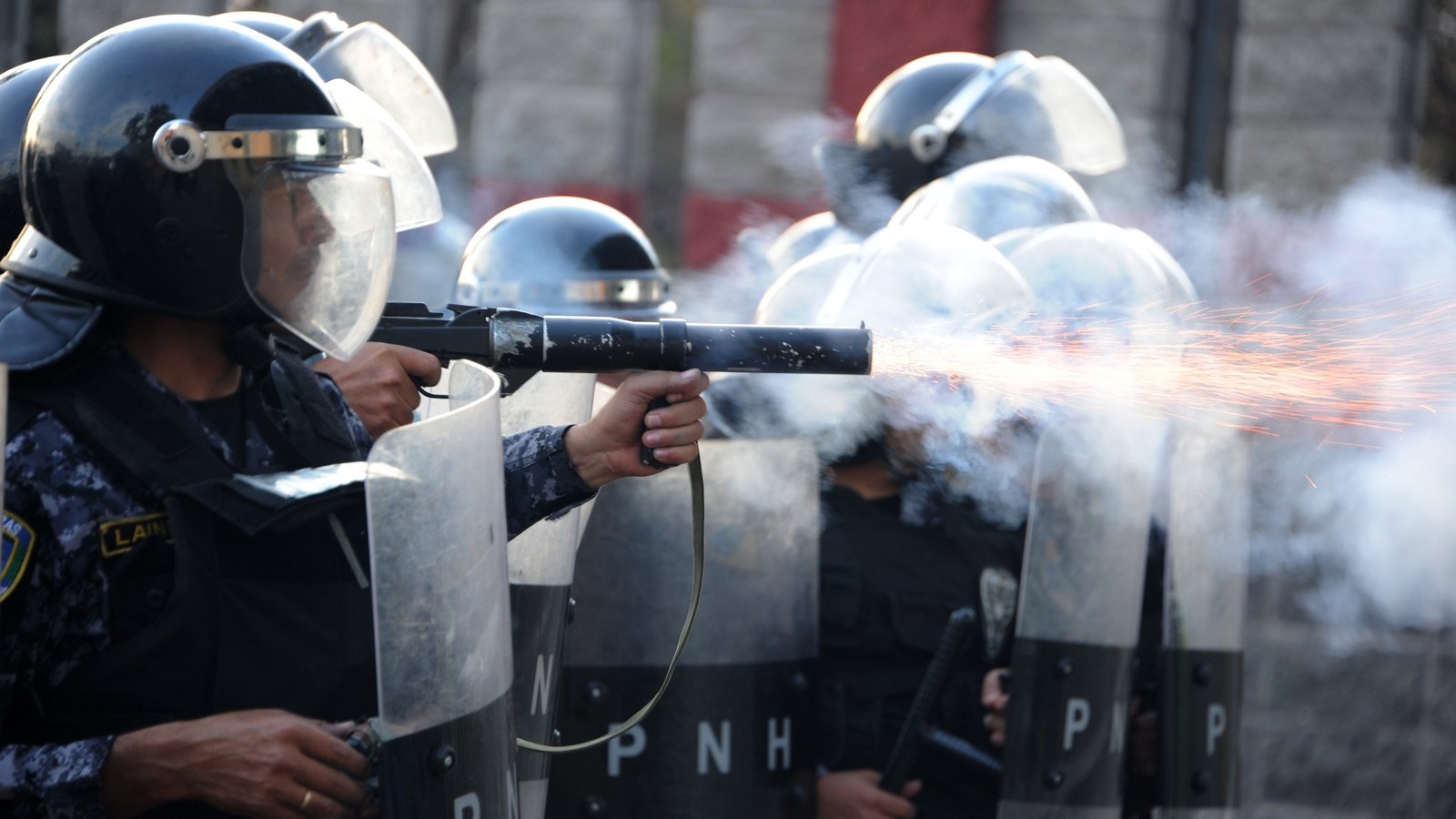 Police use tear gas at students protesting after a killing in Honduras