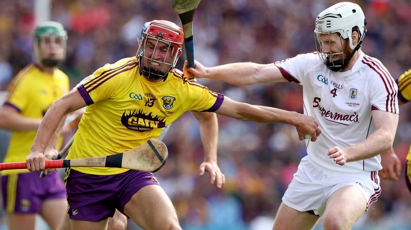 Galway's John Hanbury with Paul Morris of Wexford