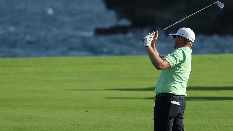 Brice Garnett plays his second shot on the 18th