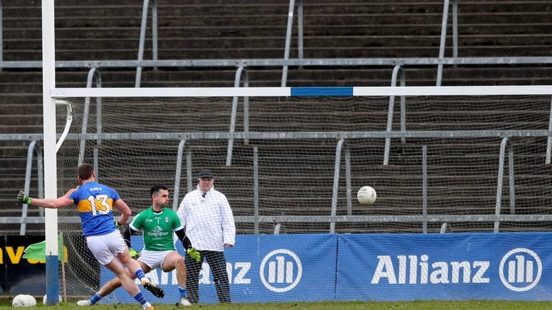 Tipperary's Conor Sweeney scores a penalty past goalkeeper Raymond Galligan of Cavan