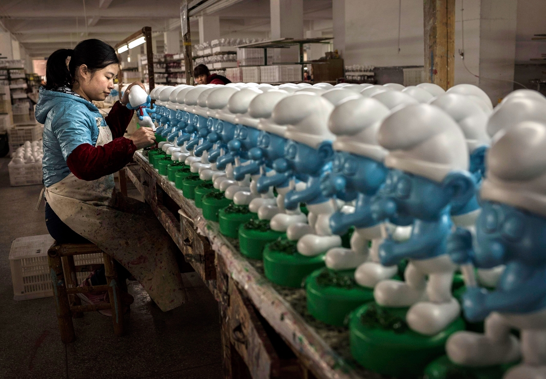 A Chinese worker paints ceramic Smurfs