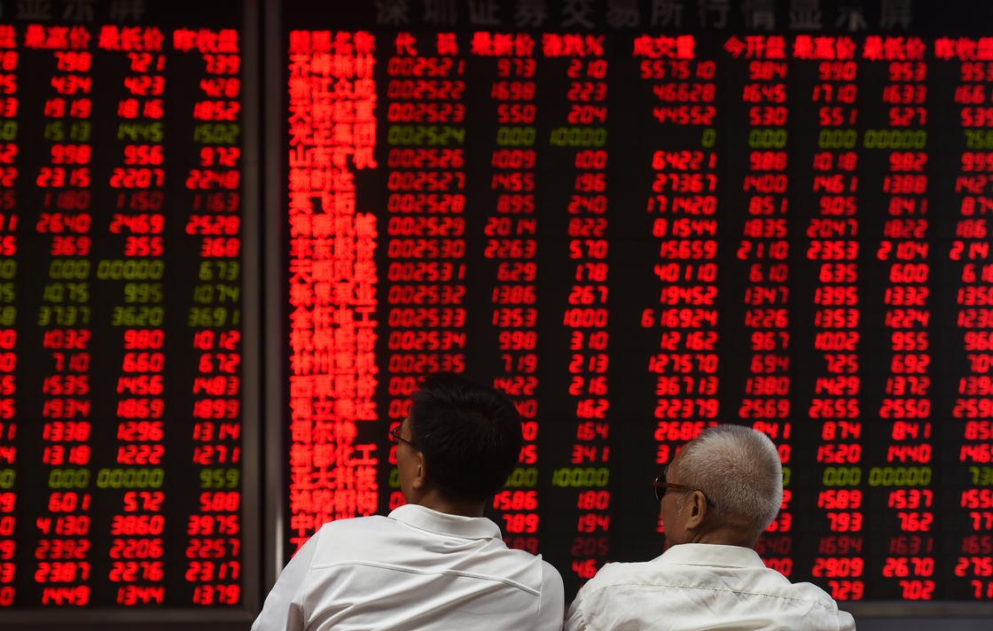 Investors monitor stock price movements in Beijing
