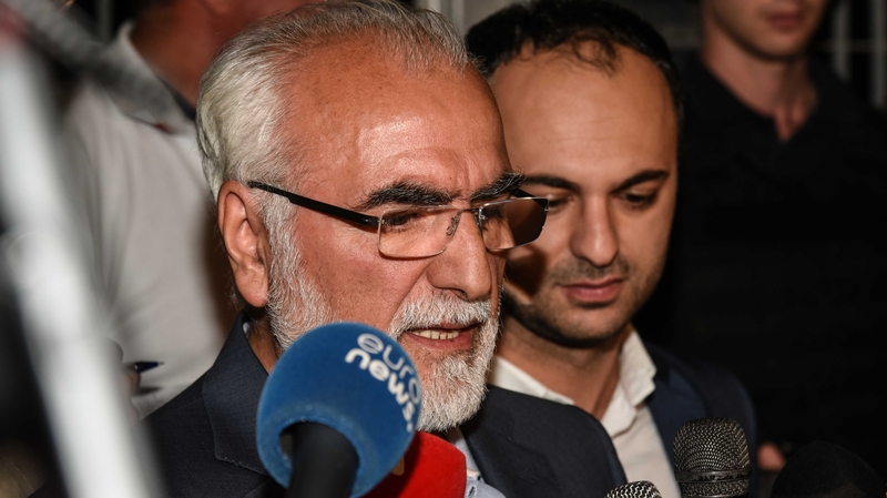 Ivan Savvides (left, speaking into the microphone) has been banned from all soccer stadiums for three years.