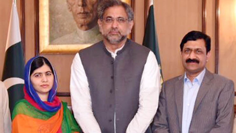 Malala Yousafzai is seen with PM Shahid Khaqan Abbasi (C) and her father