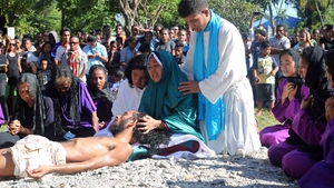 East Timorese Christian devotees re-enact the crucifixion of Jesus Christ in Dili