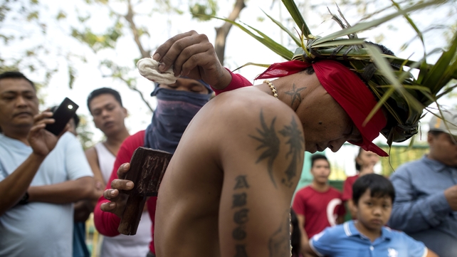 Elsewhere in the Philippines, RJ Rivera has his back wounded to bleed as part of his penitence in the village of San Juan, Pampanga