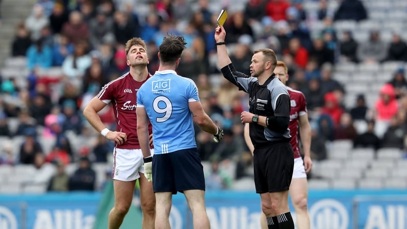 Referee Anthony Nolan books Dublin's Michael Darragh Macauley and Paul Conroy of Galway