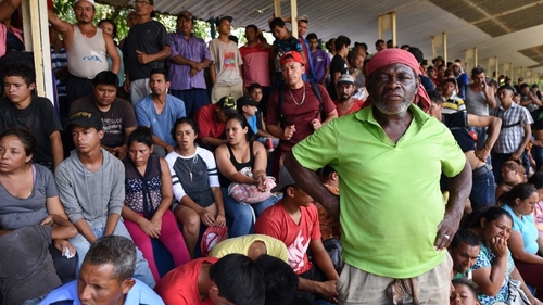Members of the migrant 'caravan' rest while heading across Mexico towards the US border