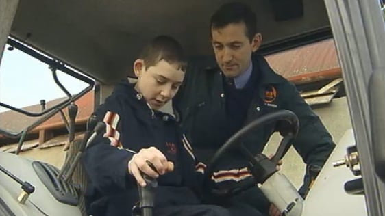 Jim Dockery teaching teenager how to drive a tractor (2003)