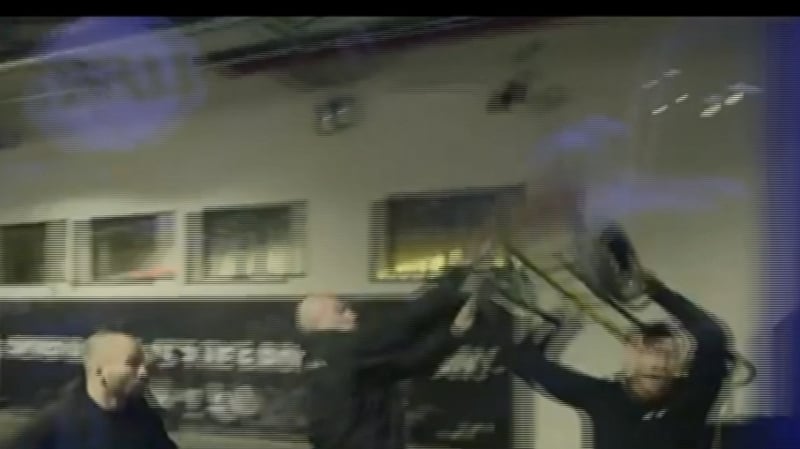 The footage shows McGregor throwing items at the bus