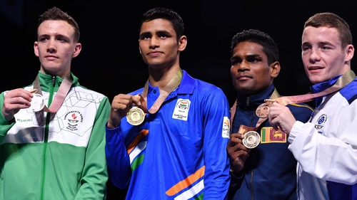 Brendan Irvine (L) poses with his silver medal