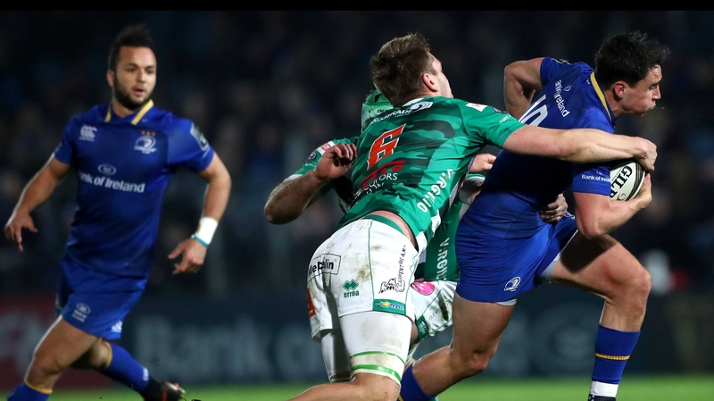 Benetton's Marco Fuser and Federico Ruzza tackle Joey Carbery of Leinster