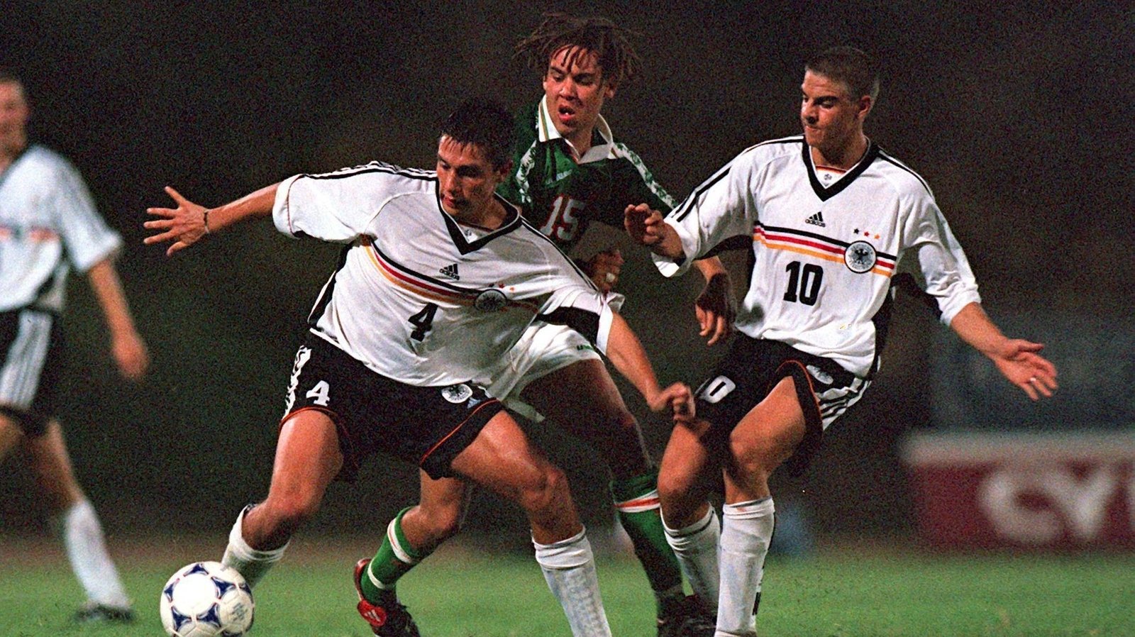 George is sandwiched by Marcel Rapp, left, and Sebastian Deisler