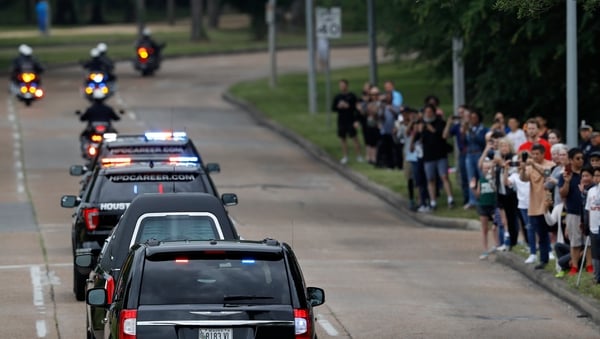 The motorcade carrying former first lady Barbara Bush's body passes Memorial Drive in Houston, Texas, today