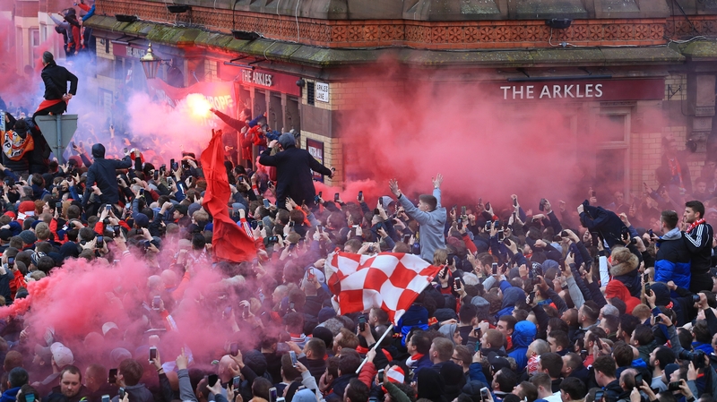 Liverpool fans greet Manchester City's team bus ahead of the Champions League quarter-final first leg at Anfield