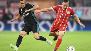 Franck Ribery (R) challenges Real Madrid's Spanish midfielder Lucas Vazquez