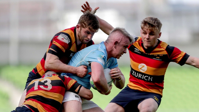 David McCarthy tackled by Harry Brennan and Ian Fitzpatrick