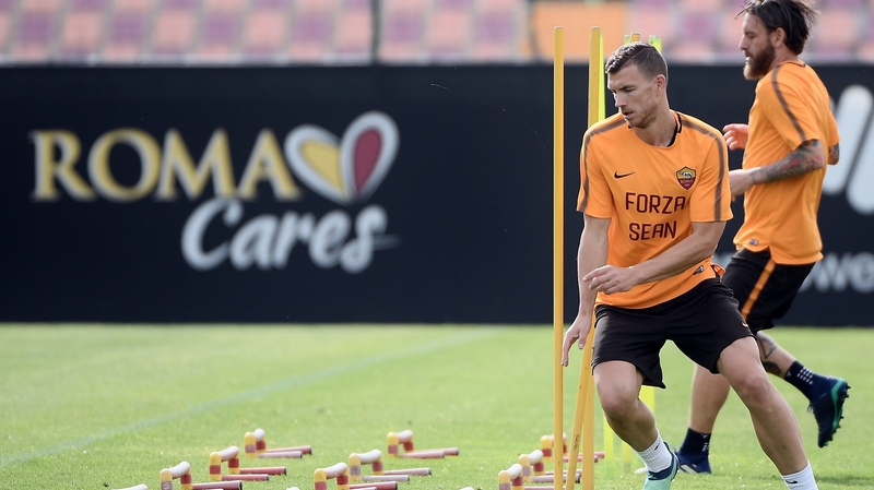 Roma forward Edin Dzeko trains while wearing a t-shirt in support of stricken Liverpool fan Sean Cox