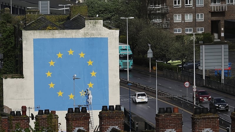 A mural by Banksy in the British port town of Dover shows a worker chipping away an EU star