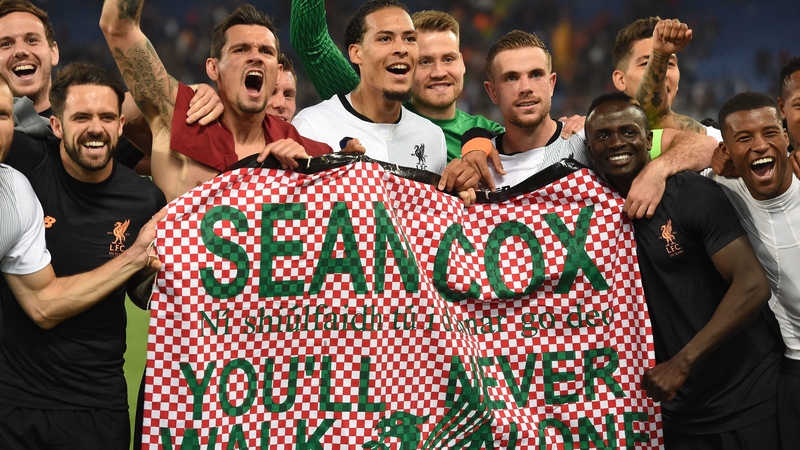 Liverpool players display a banner in honour of Sean Cox after reaching the Champions League final