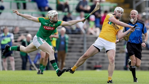 Antrim's Conor Carson scores a point despite Damien Healy's attentions