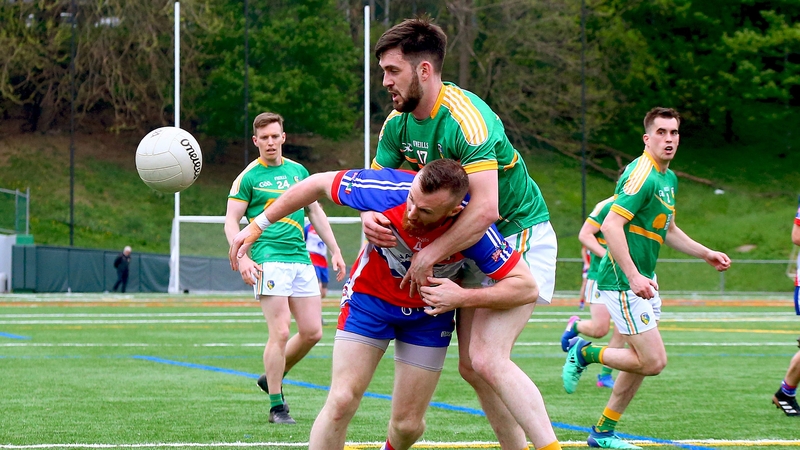 Leitrim matchwinner Noel Plunkett grapples with New York's Colin Keane in last night's game in Gaelic Park