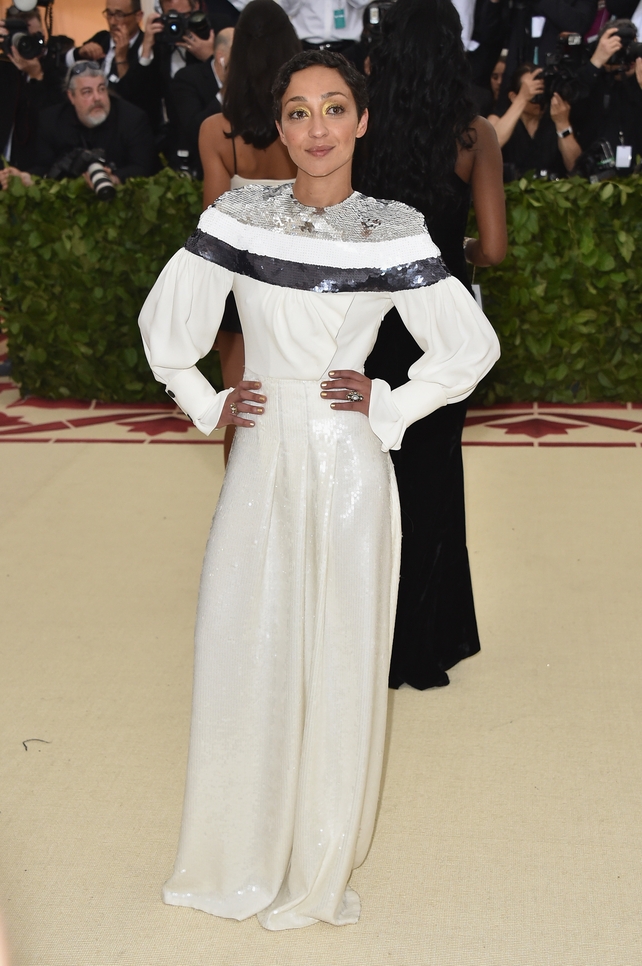 Ruth Negga wore a white Vuitton gown to the 2018 Met Gala. Theme: Heavenly Bodies: Fashion and the Catholic Imagination.