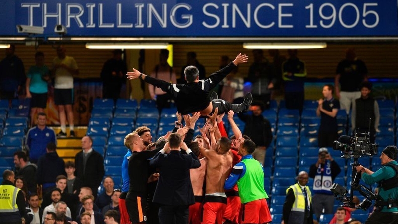Huddersfield Town's German head coach David Wagner is thrown in the air by his players and staff