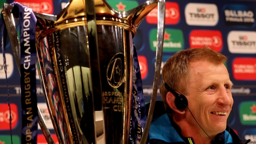 Cullen sits and smiles beside the silverware