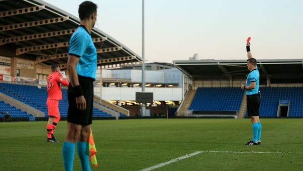 Ireland goalkeeper James Corcoran is shown a red card by referee Zbynek Proske