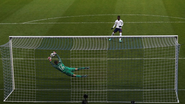 Joey Koorevaar of the Netherlands saves a penalty from England's Folarin Balogun