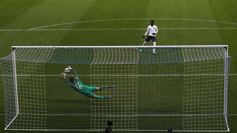 Joey Koorevaar of the Netherlands saves a penalty from England's Folarin Balogun