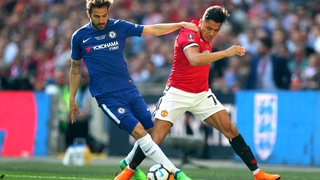 Cesc Fabregas of Chelsea battles for possession with Alexis Sanchez of Manchester United