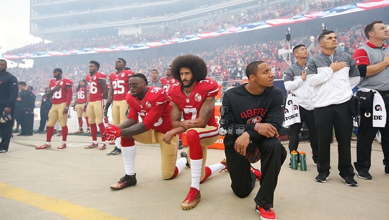 Colin Kaepernick kneels during the national anthem