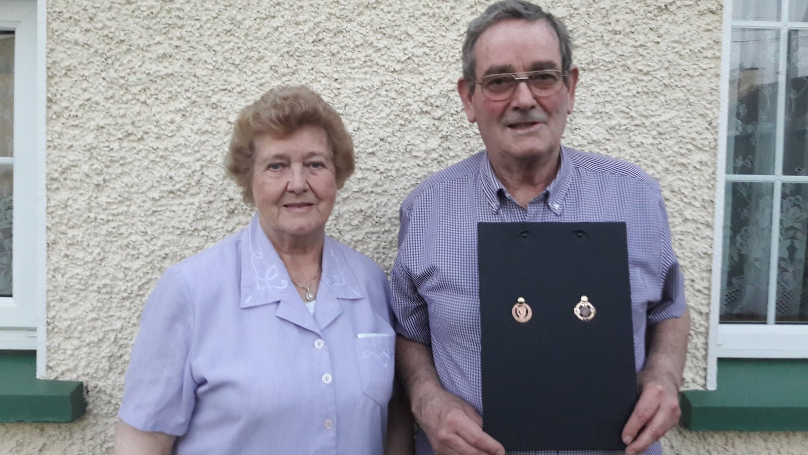 Seamus Flynn and his wife Mary pose with two of his medals
