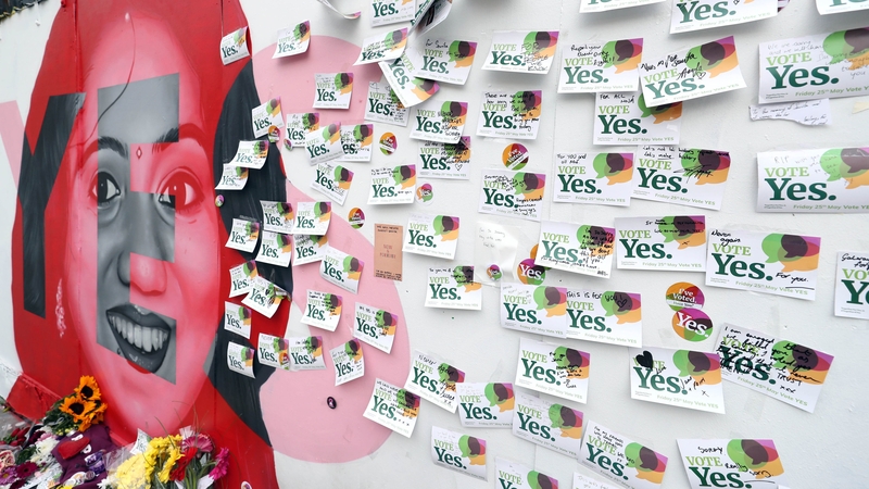 The mural of Savita Halappanavar by artist Aches covered in messages and flowers