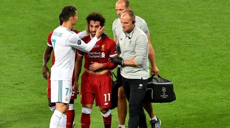 Mo Salah is consoled by Cristiano Ronaldo as he leaves the field