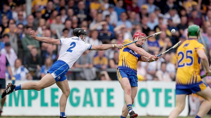 Clare's John Conlon scores a point despite the attention of Shane Fives