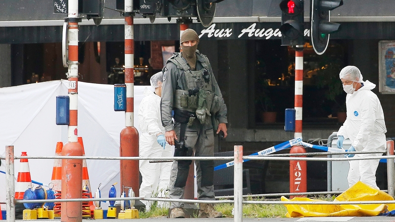 Forensic specialists examine one of the scenes where four people died, including the gunman