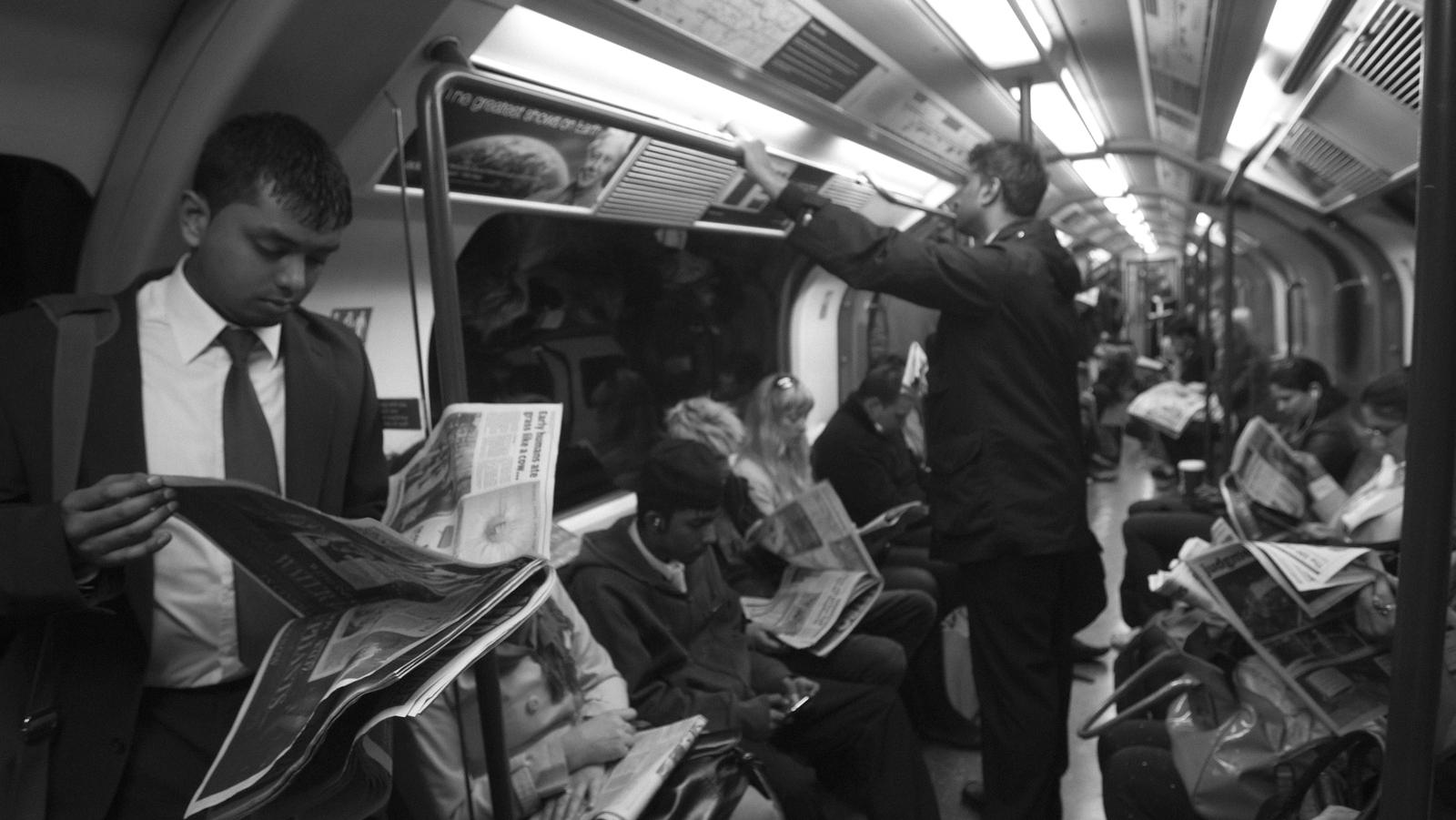 Commuters reading newspapers