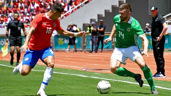 Costa Rica's Christian Gamboa (L) and Northern Ireland's Stuart Dallas vie for the ball