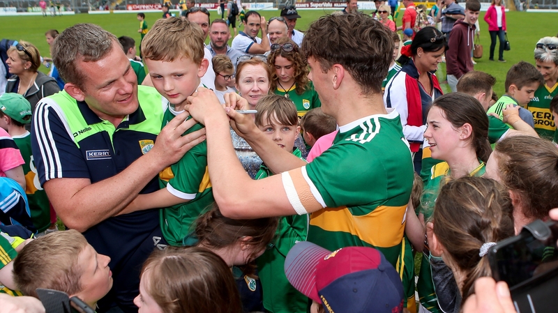 David Clifford signs a young fan's jersey