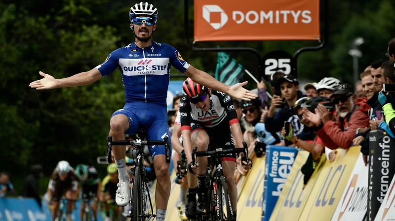 France's Julian Alaphilippe celebrates as he crosses the finish line ahead of Ireland's Daniel Martin (Rear C)