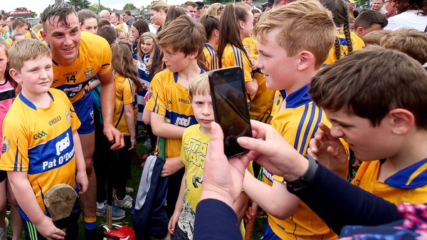 Peter Duggan poses with fans after the game