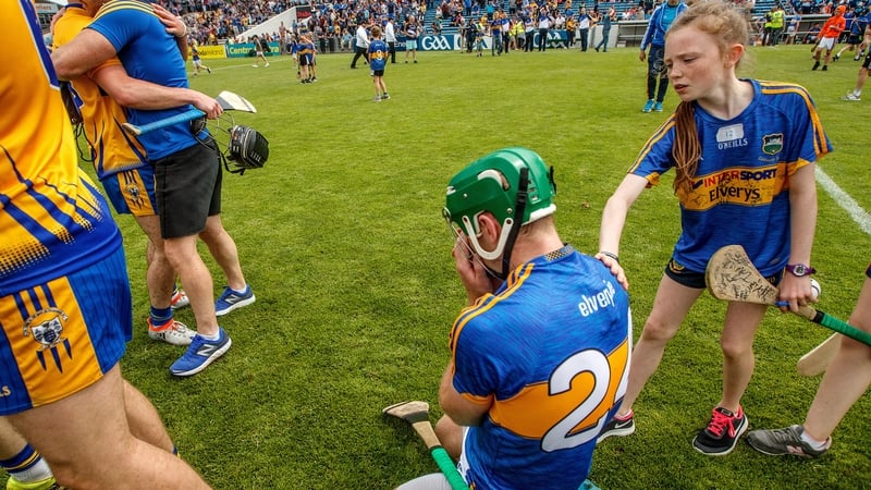 A young Tipperary fan consoles Noel McGrath following the defeat to Clare at Semple Stadium