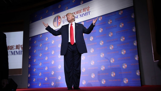 Donald Trump answers a final question while departing a press conference following his meeting with the North Korean leader