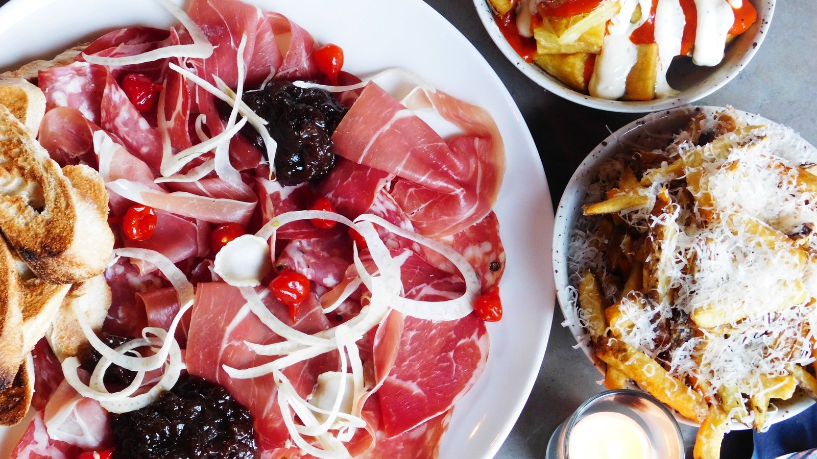 The nibbles - the charcuterie board, parmesan fries and patatas bravas